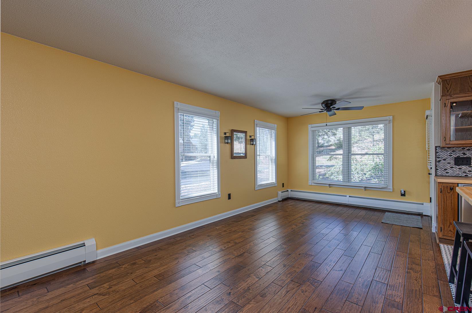 130 Hidden Treasure, Unit 1 Durango, CO 81301 - Photo 10 of 32 a view of an empty room with a window and wooden floor