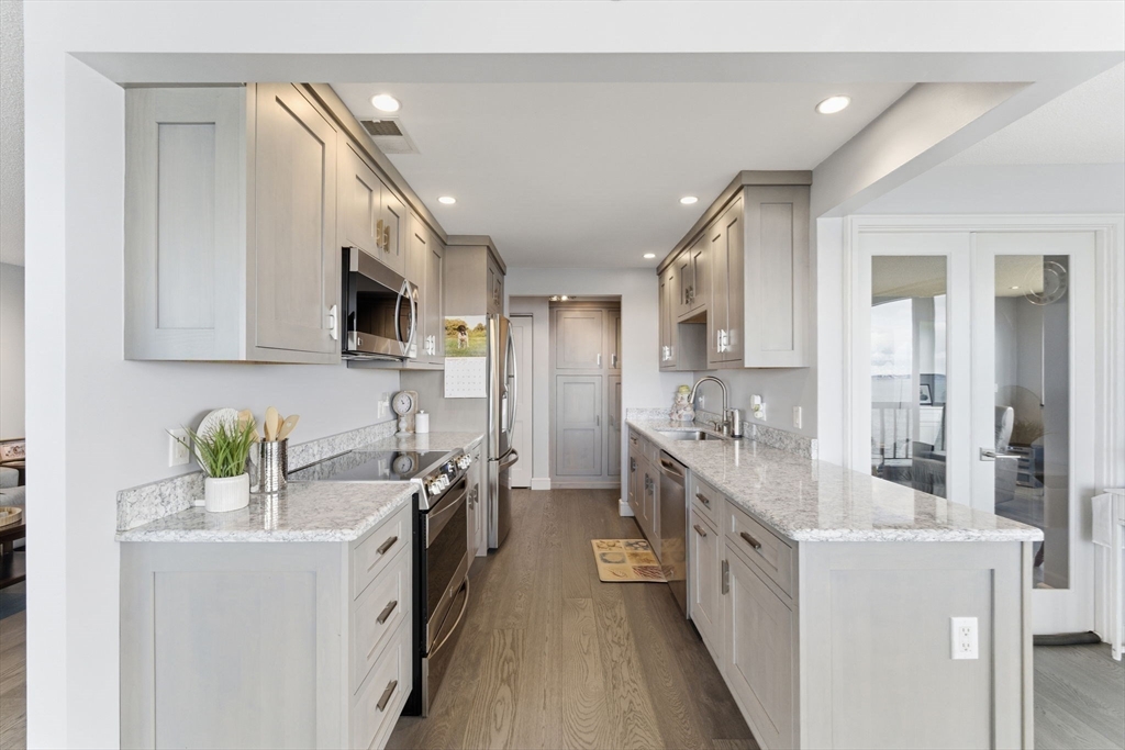 3 Seal Harbor Road, Unit 736 Winthrop, MA 02152 - Photo 6 of 41 a kitchen with stainless steel appliances sink a microwave and cabinets