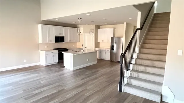 a view of kitchen with sink and wooden floor