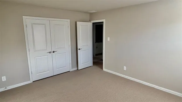 an empty room with closet area