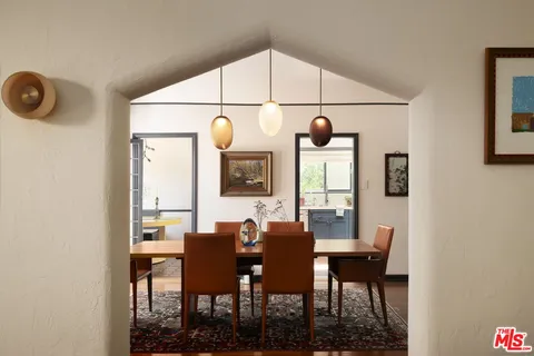 a view of a dining room with furniture and window