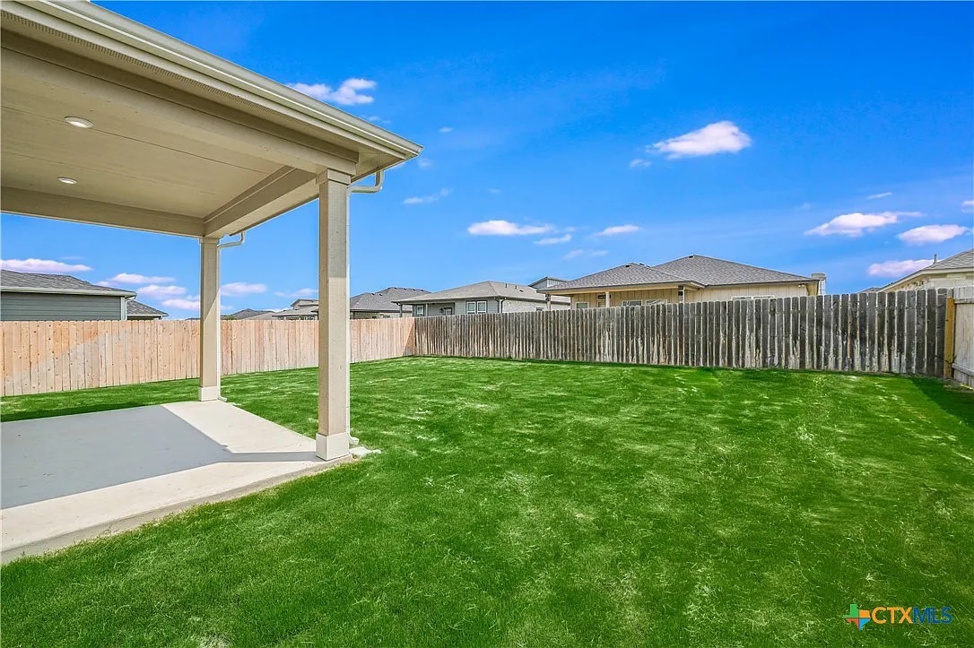 157 Seattle Slew Drive Jarrell, TX 76537 - Photo 35 of 37 Fenced backyard featuring a patio and a residential view