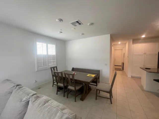 a view of a room with furniture and windows