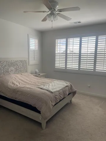 a bedroom with a bed and window