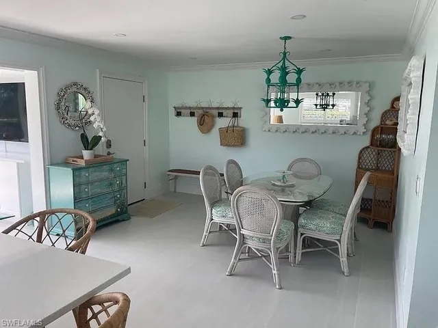 a dining room with furniture and a chandelier