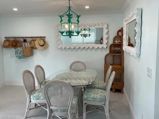 a view of a dining room with furniture and chandelier