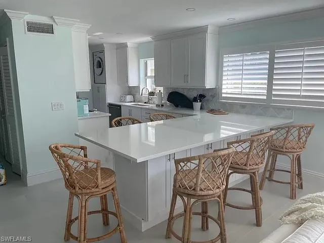 a kitchen with a table chairs and a refrigerator