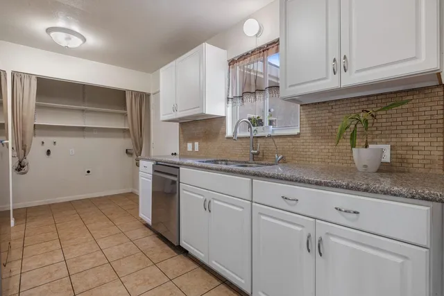 a bathroom with a sink vanity and a toilet