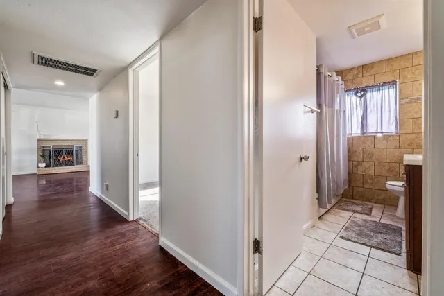 a bathroom with a sink vanity and a toilet