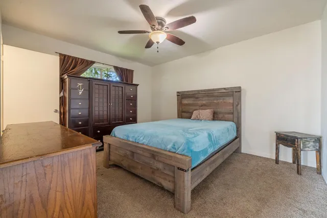 a bathroom with a sink a toilet a mirror and shower curtain
