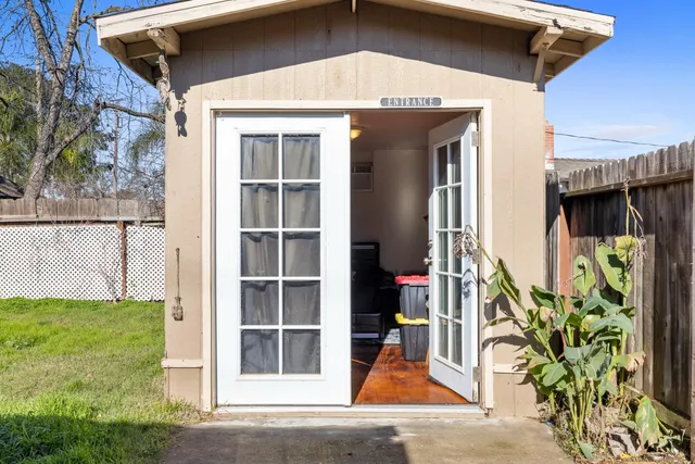 a view of a room with wooden walls and door