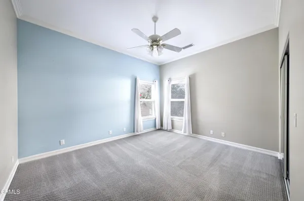 a view of an empty room with a ceiling fan