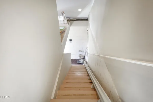 a view of a hallway with wooden floor and entryway