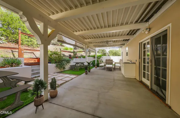 a view of a porch with furniture and garden