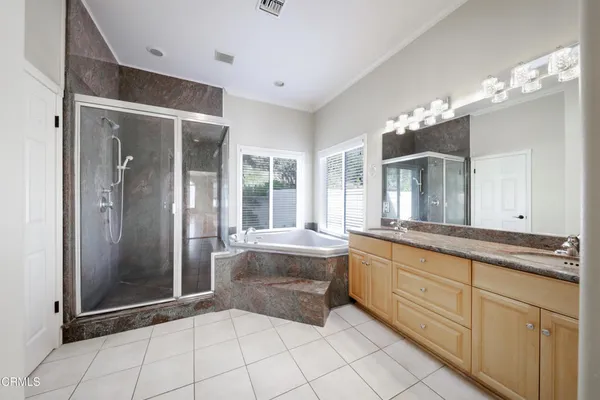 a large bathroom with a large tub and sink