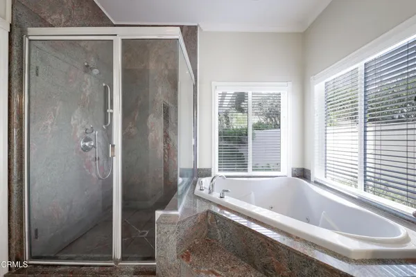 a bathroom with a bathtub and shower