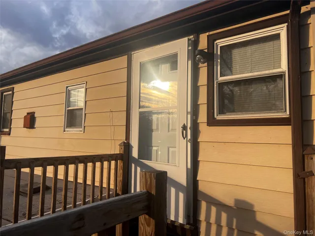 a view of a door and wooden floor