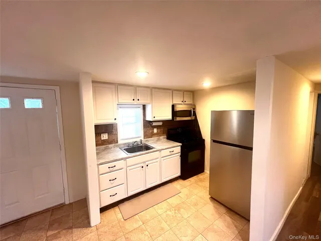 a kitchen with a refrigerator and a stove