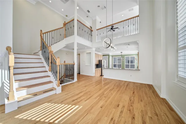 a view of an empty room with a window and kitchen view
