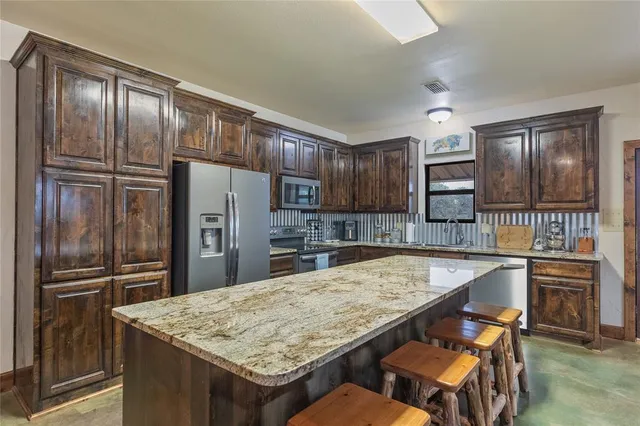 a view of a backyard with table and chairs