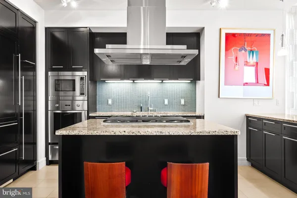 a kitchen with stainless steel appliances granite countertop a stove and a refrigerator