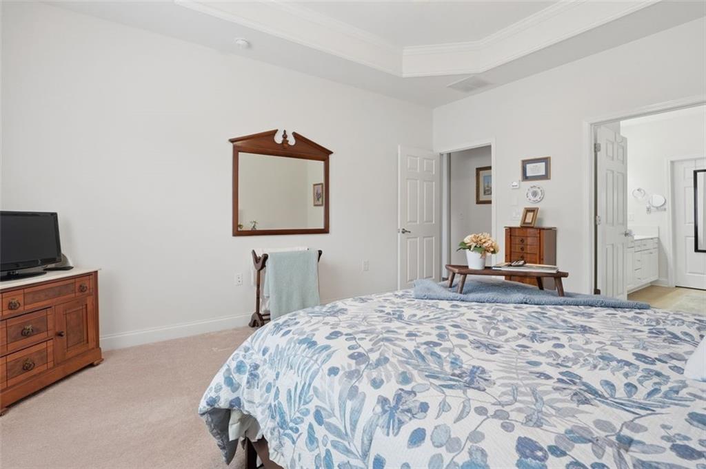 3328 Ivy Ridge Court Buford, GA 30519 - Photo 27 of 34 a bedroom with a bed and a flat screen tv
