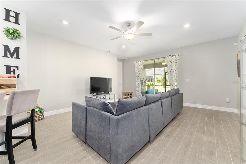 1244 Southeast 42nd Road Ocala, FL 34480 - Photo 11 of 56 a living room with furniture and a flat screen tv