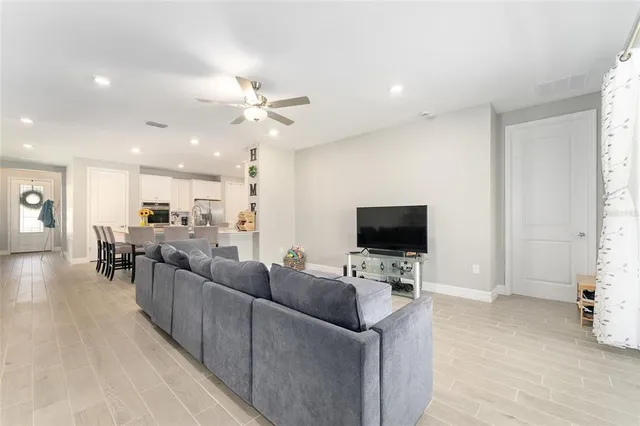 a view of a hallway with wooden floor and a potted plant