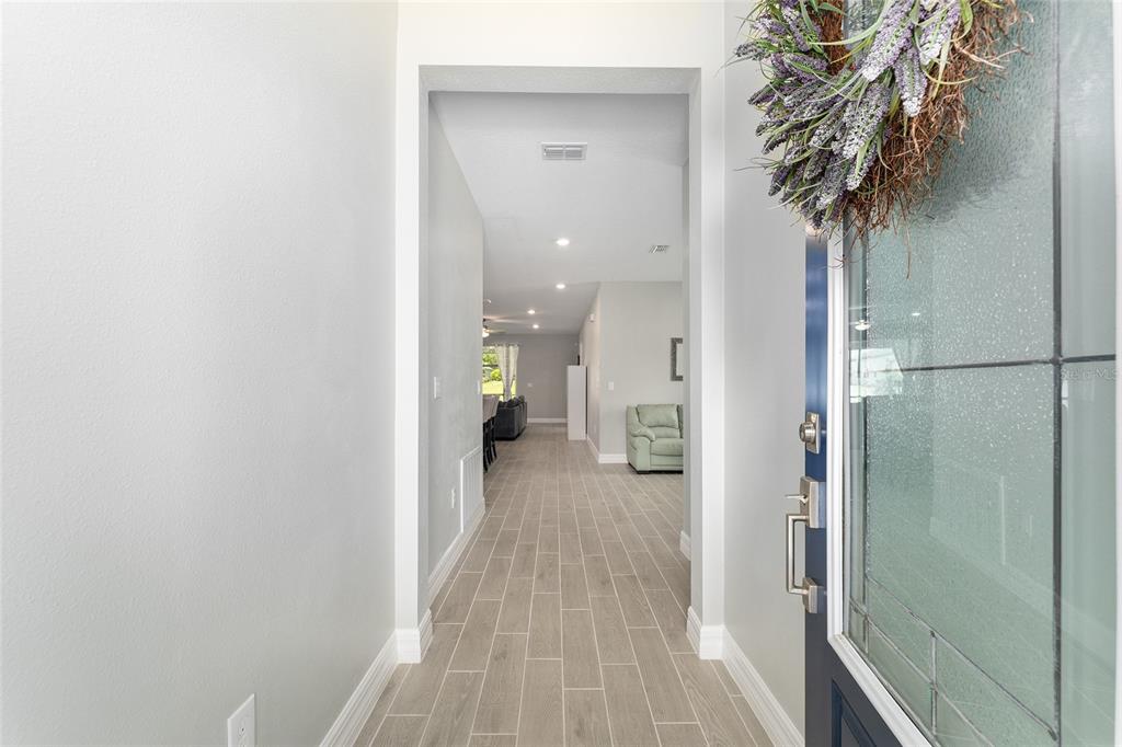 1244 Southeast 42nd Road Ocala, FL 34480 - Photo 15 of 56 a view of a hallway with a potted plant on a table