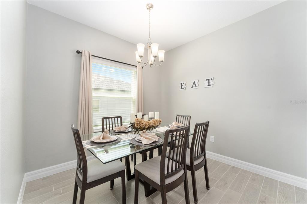 1244 Southeast 42nd Road Ocala, FL 34480 - Photo 19 of 56 a view of a dining room with furniture window and chandelier