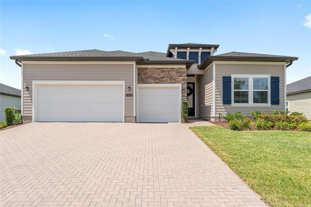 1244 Southeast 42nd Road Ocala, FL 34480 - Photo 2 of 56 a front view of a house with a yard and garage