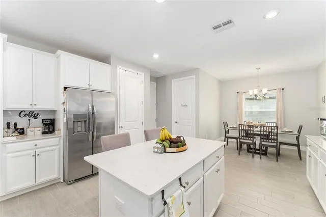 a kitchen with a sink stainless steel appliances and white cabinets