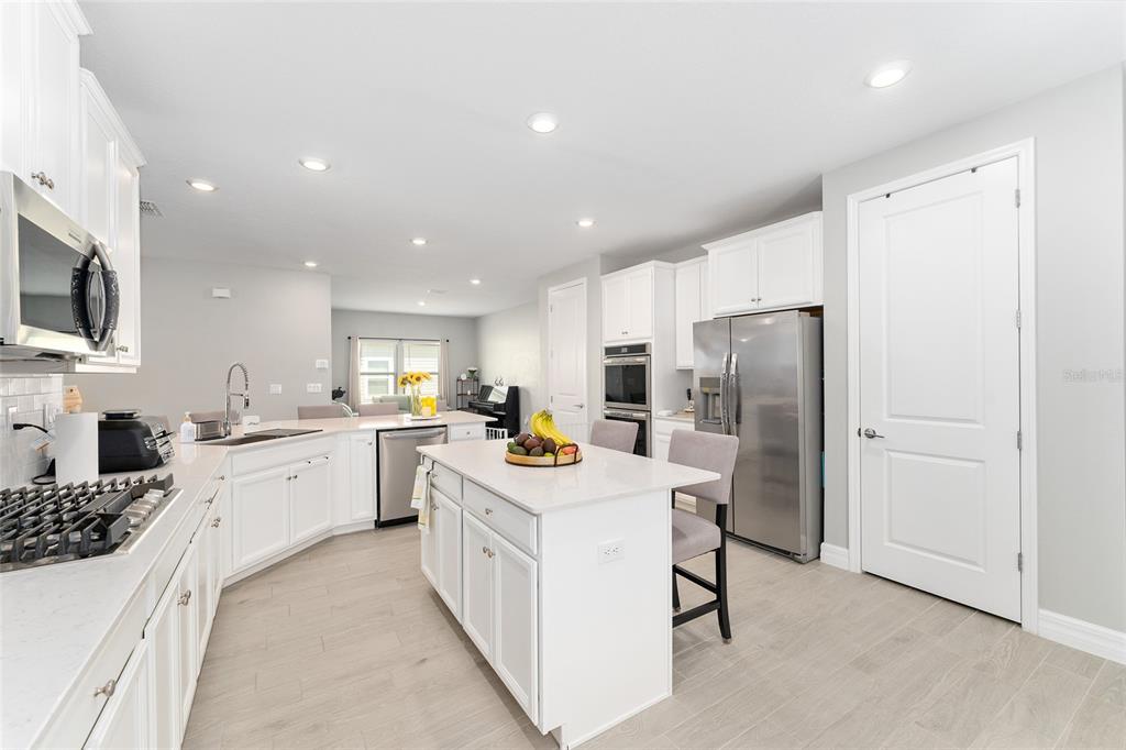 1244 Southeast 42nd Road Ocala, FL 34480 - Photo 23 of 56 a kitchen with a sink stainless steel appliances and white cabinets
