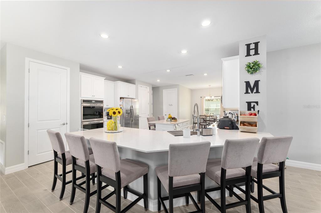 1244 Southeast 42nd Road Ocala, FL 34480 - Photo 28 of 56 a dining room with stainless steel appliances a table and chairs