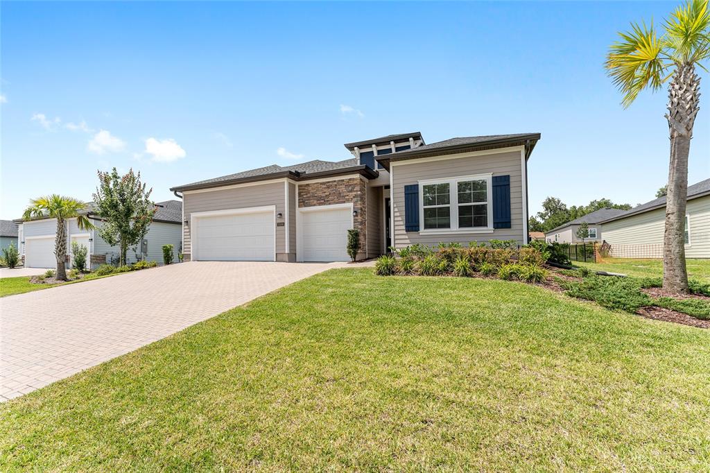 1244 Southeast 42nd Road Ocala, FL 34480 - Photo 3 of 56 a front view of house with yard and trees in the background