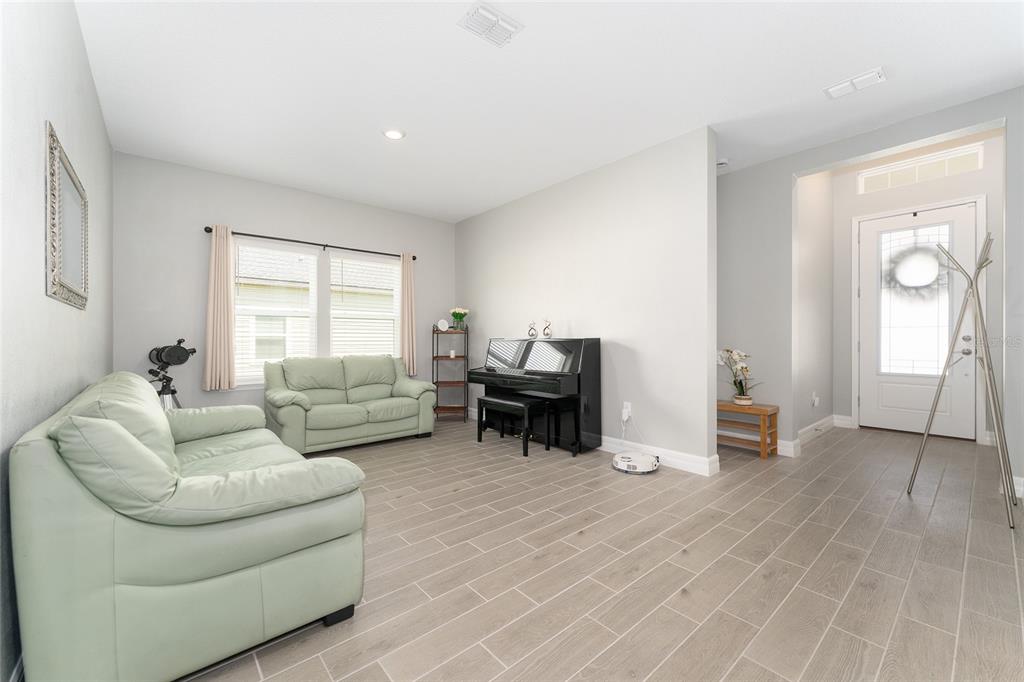 1244 Southeast 42nd Road Ocala, FL 34480 - Photo 31 of 56 a living room with furniture and a wooden floor