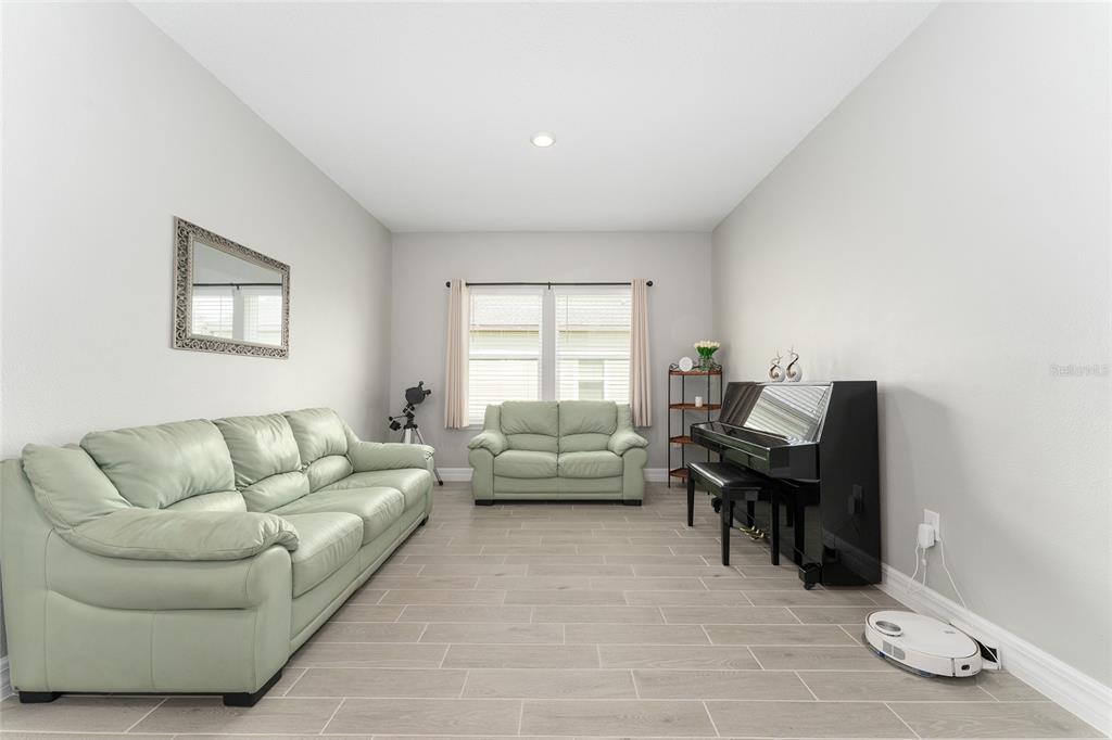 1244 Southeast 42nd Road Ocala, FL 34480 - Photo 32 of 56 a living room with furniture and a couch