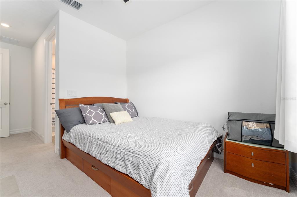 1244 Southeast 42nd Road Ocala, FL 34480 - Photo 35 of 56 a bedroom with a bed and lamp