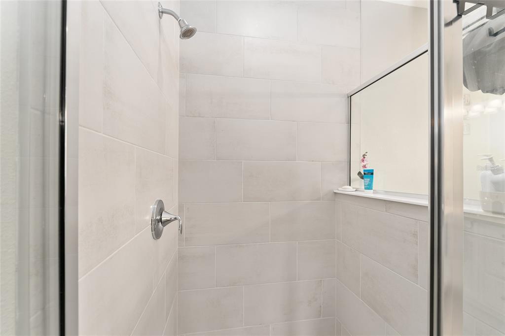 1244 Southeast 42nd Road Ocala, FL 34480 - Photo 39 of 56 a bathroom with a shower and a glass door