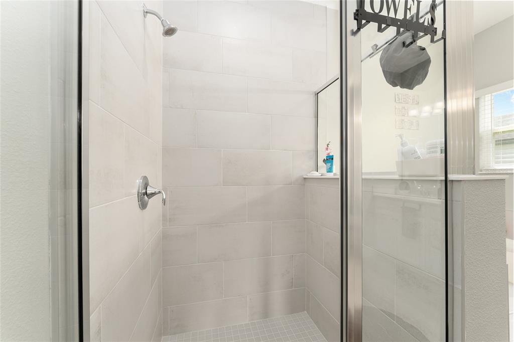 1244 Southeast 42nd Road Ocala, FL 34480 - Photo 40 of 56 a bathroom with a glass shower door