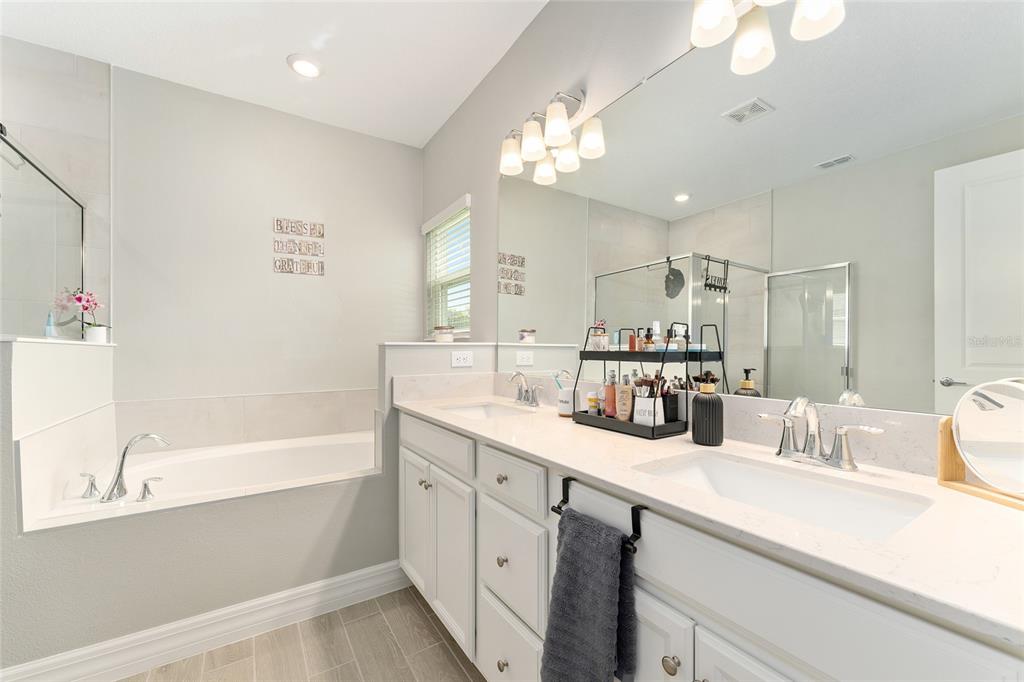 1244 Southeast 42nd Road Ocala, FL 34480 - Photo 42 of 56 a bathroom with a tub sink and mirror