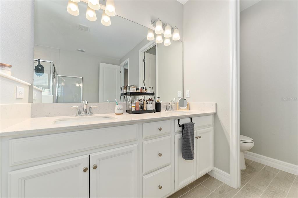 1244 Southeast 42nd Road Ocala, FL 34480 - Photo 43 of 56 a bathroom with double vanity and a mirror