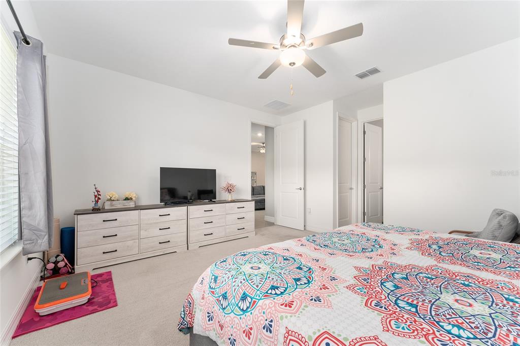 1244 Southeast 42nd Road Ocala, FL 34480 - Photo 47 of 56 a bedroom with a bed and a flat tv screen on dresser