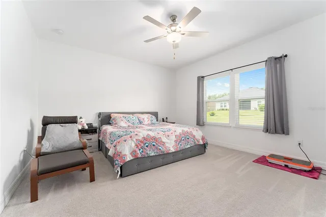 a bedroom with a bed dresser and a window