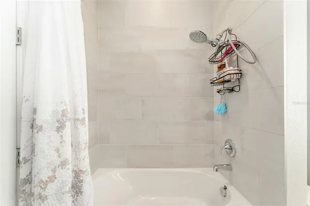 a view of a bedroom with gym equipment and a chandelier
