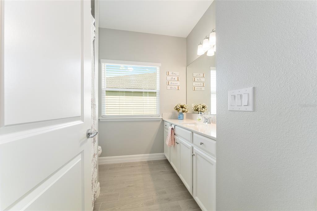 1244 Southeast 42nd Road Ocala, FL 34480 - Photo 52 of 56 a bathroom with a sink a toilet and a mirror