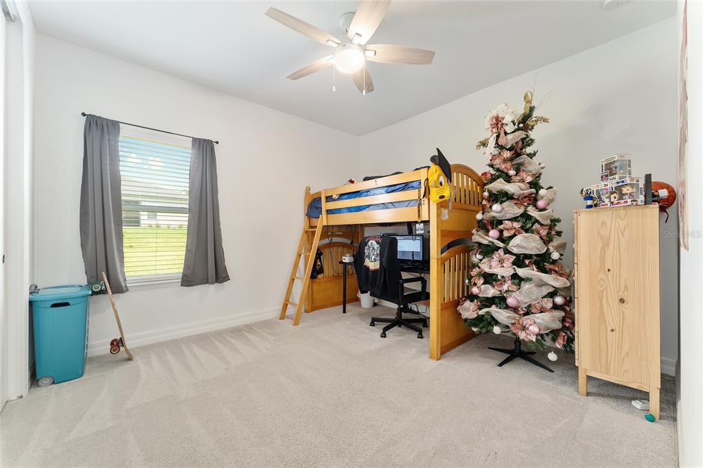1244 Southeast 42nd Road Ocala, FL 34480 - Photo 56 of 56 a view of a bedroom with gym equipment and a chandelier