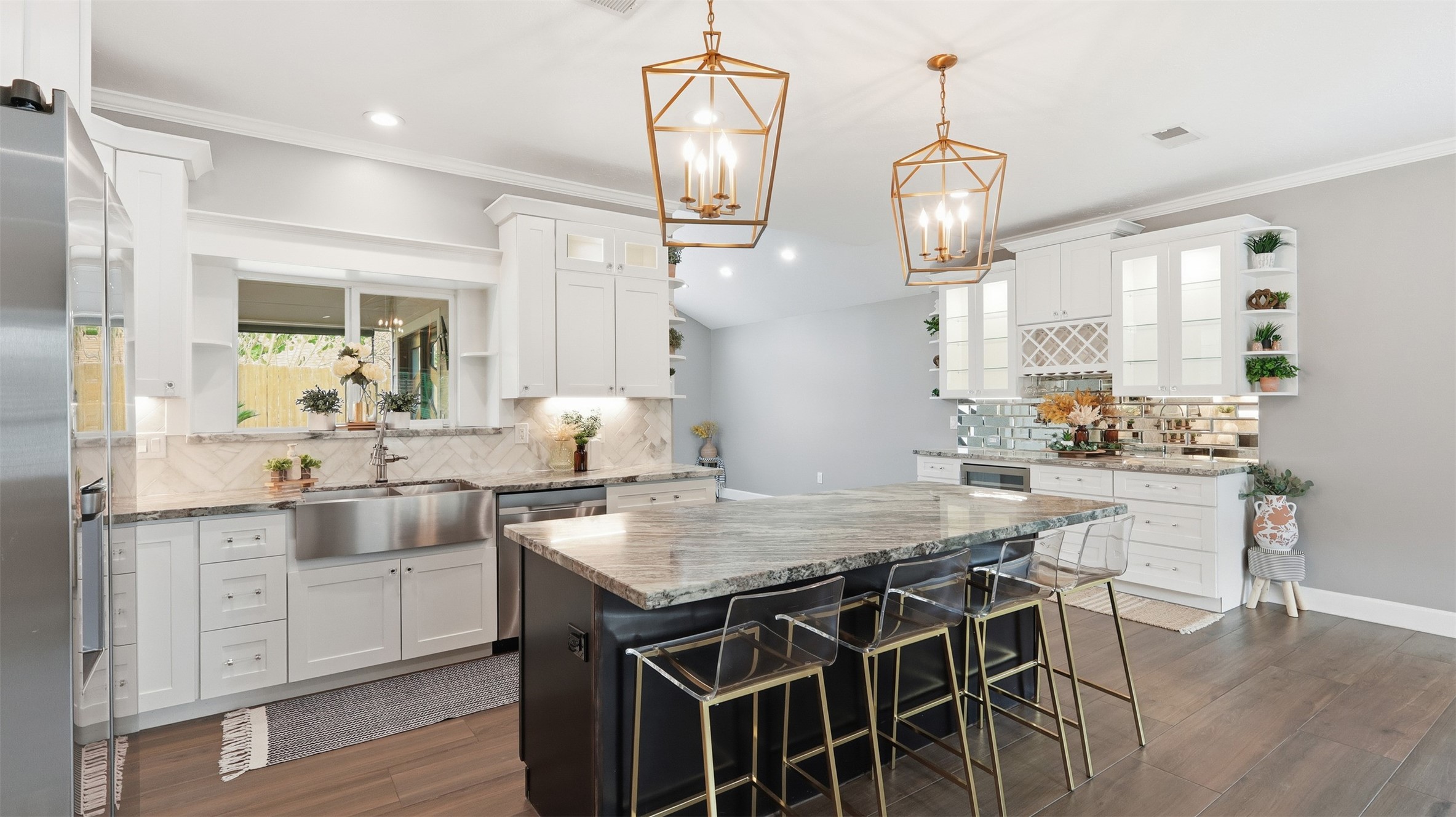 a kitchen with stainless steel appliances a dining table chairs and wooden floor