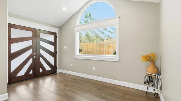 a bathroom with a sink vanity granite and a shower