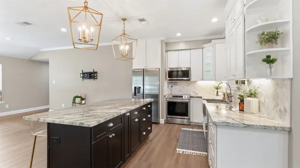 a bathroom with a granite countertop sink mirror vanity and toilet